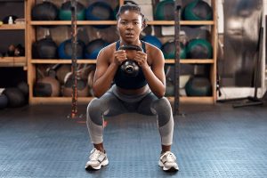 black woman dumbell squats 590870502 DS